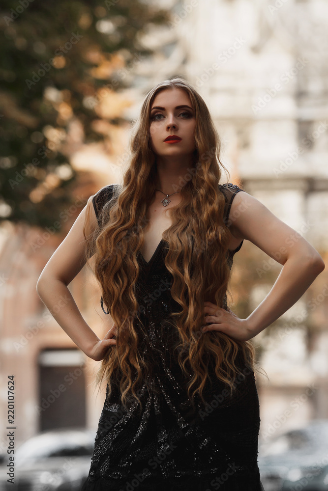 Portrait goth girl outdoor. Wearing black dress, white skin red lips ...