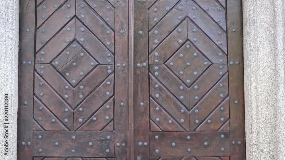Old wooden entrance door. Wooden door with ancient patten. Ancient wooden door.
Old wooden entrance door. Wooden door with ancient patten. Ancient wooden door.