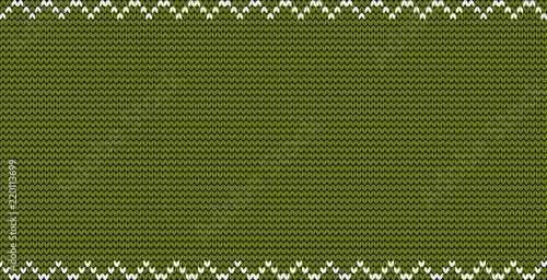 Green knitted fabric background with zig zag border frame and empty copy space for text.