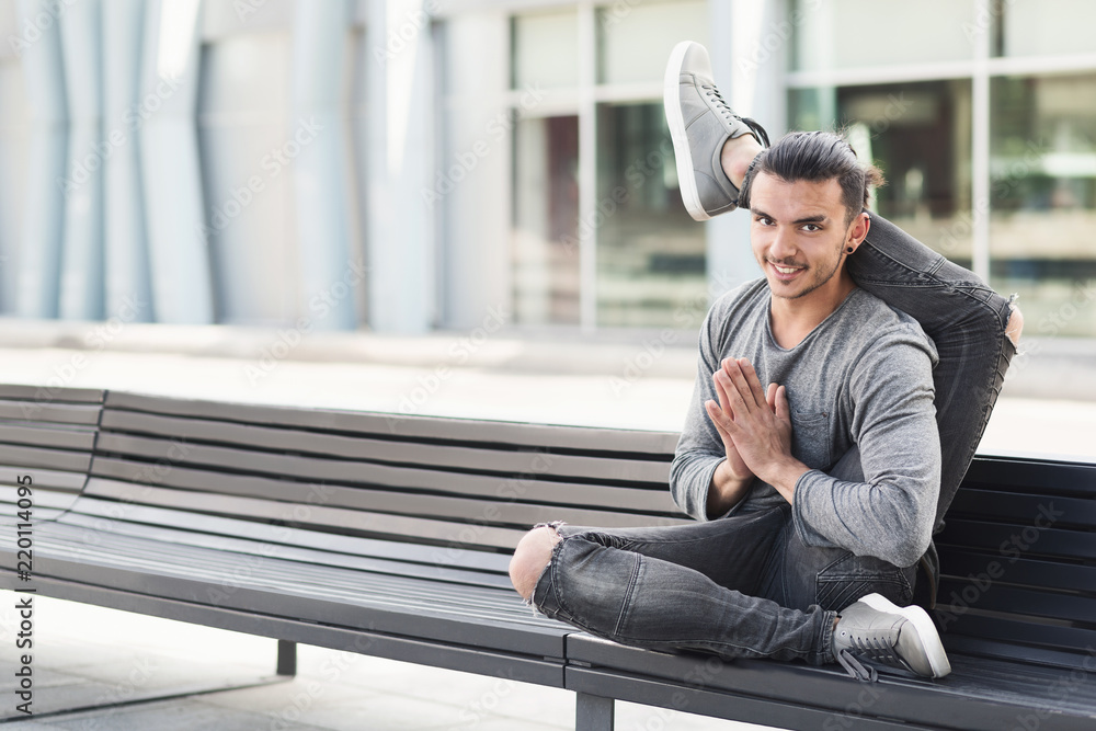 Man practicing advanced yoga pose in urban area Man practicing advanced yoga pose in urban area