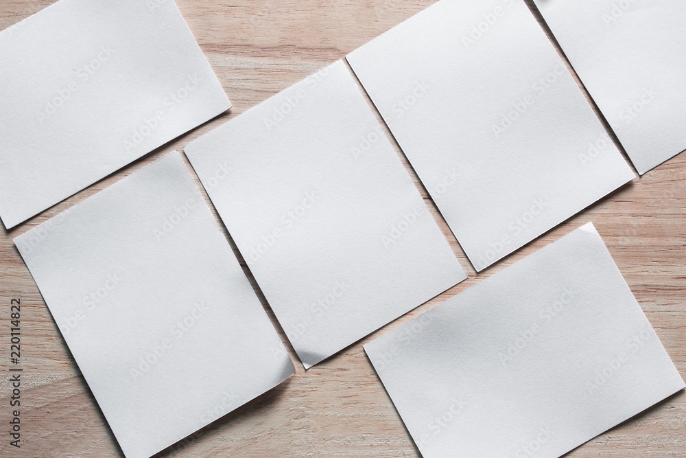 Blank portrait mock-up paper. brochure magazine isolated on brown wooden table, changeable background / white paper isolated on wood Blank portrait mock-up paper. brochure magazine isolated on brown wooden table, changeable background / white paper isolated on wood