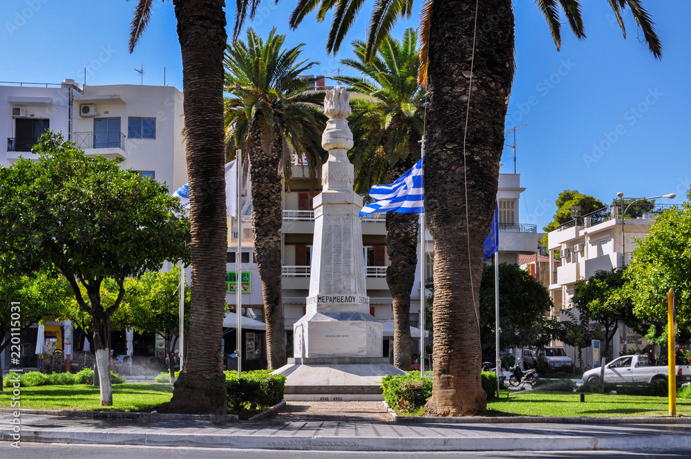 Agios Nikolaos, Crete Island / Greece. Eleftherias Square at the center of Agios Nikolaos coastal town the capital city of Lasithi prefecture. Monument to heroes. Sunny day
