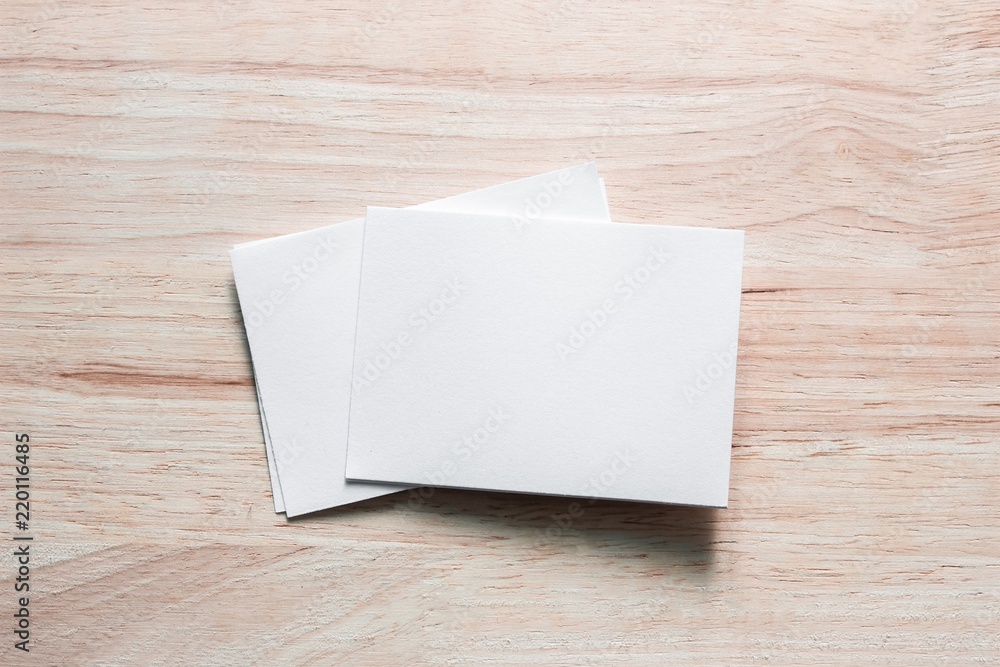 Blank portrait mock-up paper. brochure magazine isolated on brown wooden table, changeable background / white paper isolated on wood Blank portrait mock-up paper. brochure magazine isolated on brown wooden table, changeable background / white paper isolated on wood