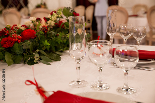 close up table decor for wedding ceremony, table setting, flowers, red and white decor