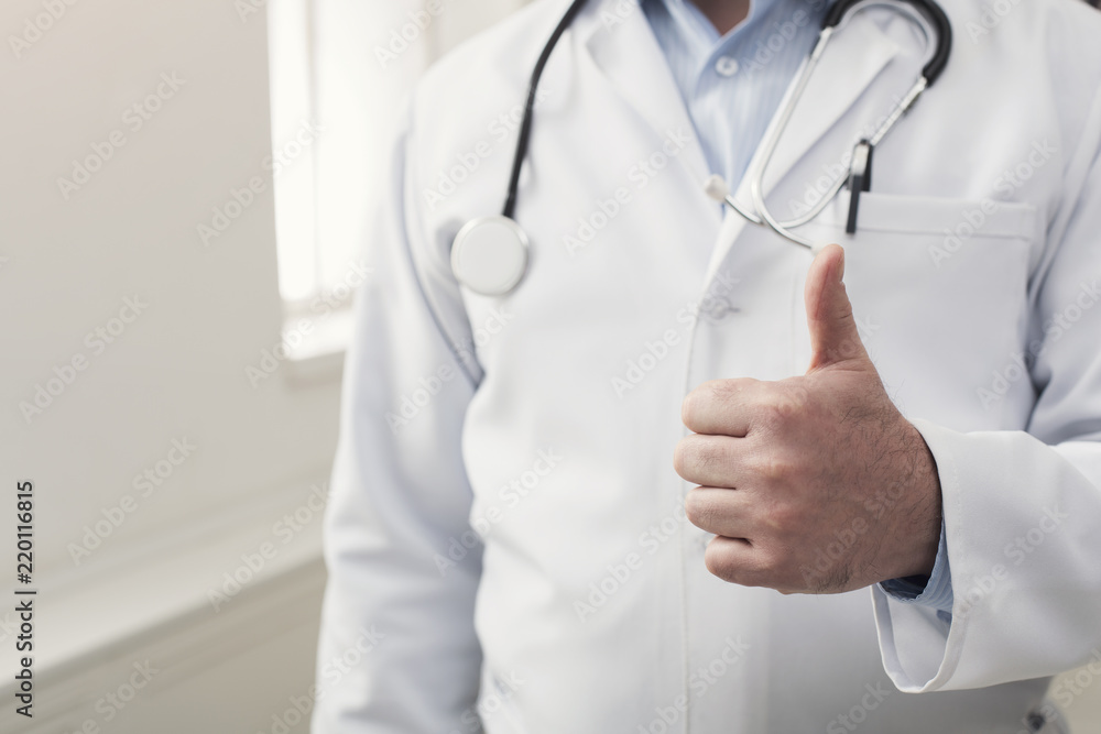 Unrecognizable doctor showing thumb up gesture Unrecognizable doctor showing thumb up gesture