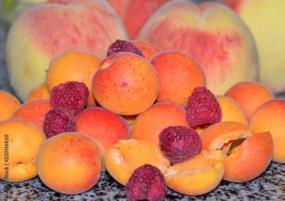 Ripe juicy apricots, raspberries and peaches, summer harvest Ripe juicy apricots, raspberries and peaches, summer harvest