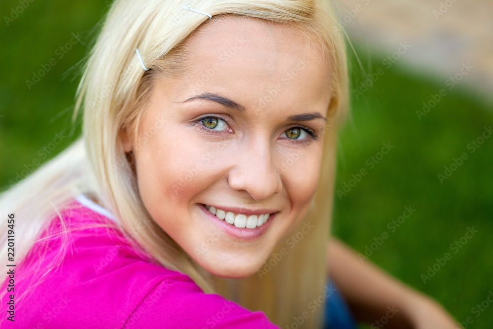 Portrait of a Smiling Young Woman in a Park Portrait of a Smiling Young Woman in a Park