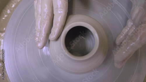 Potter's wheel. The process of making pottery in a pottery workshop. Dishes made of clay. photo