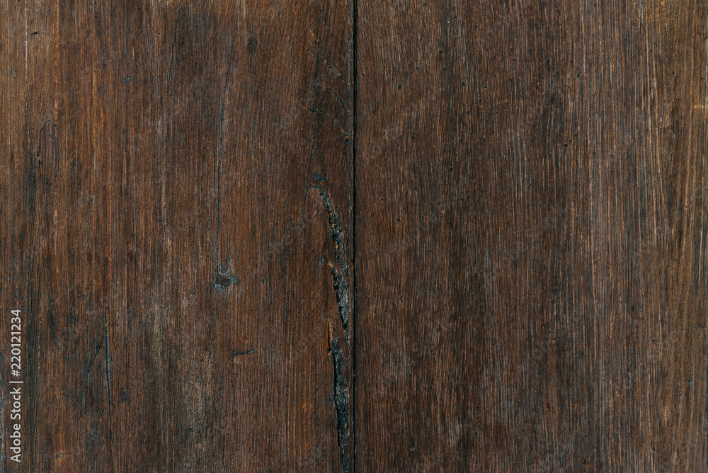 Two grungy ancient wooden planks with metal rivets in Spain. Wooden dark brown texture