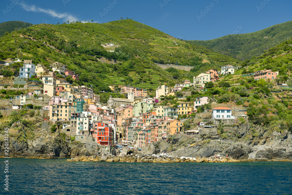 People enjoying sunny summer day in city of Riomaggiore