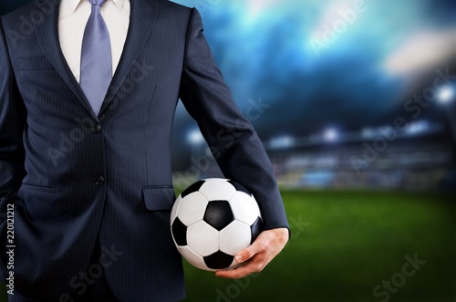 Business man hand holding football ball © BillionPhotos.com