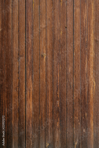 Vertical grungy ancient wooden planks in Spain. Wooden dark brown texture