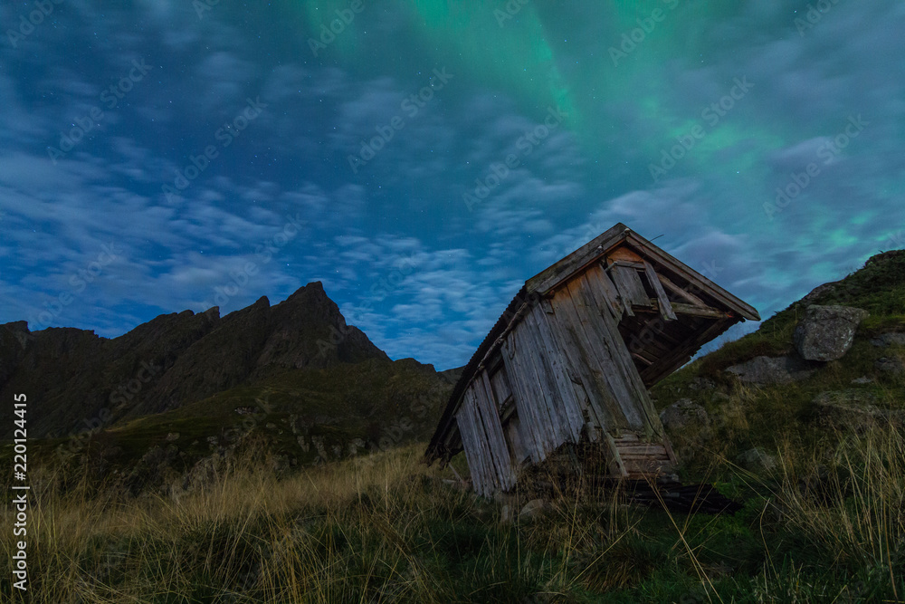 Northern lights over an old outhouse