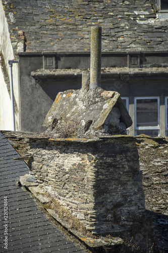 Chimney on a slate roof of an old residential house