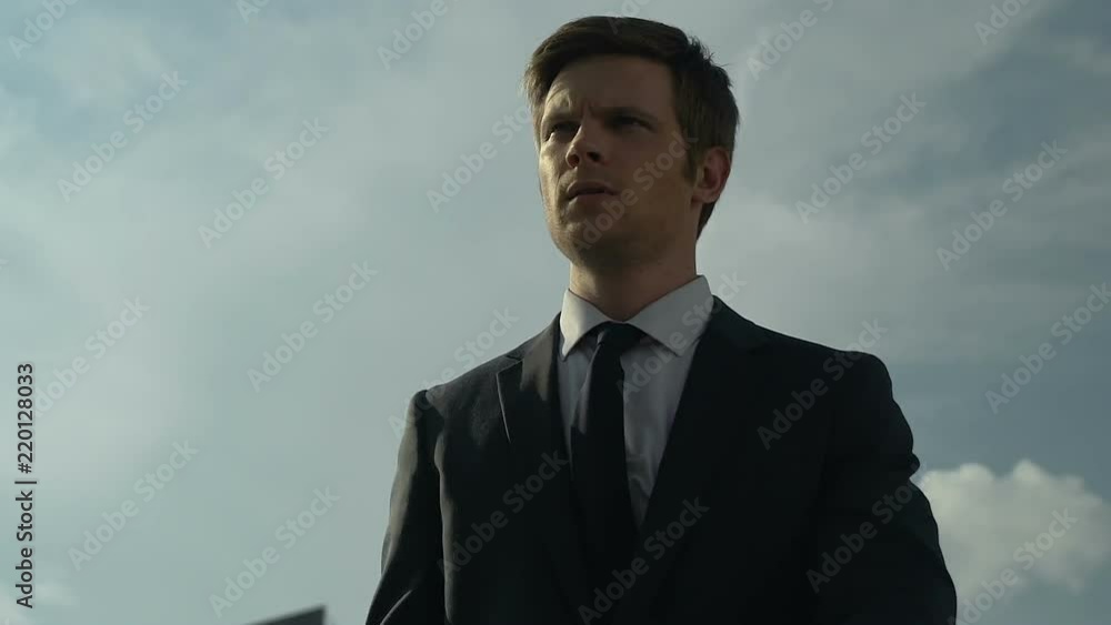 Successful handsome businessman walking around city, personal growth, trainings Successful handsome businessman walking around city, personal growth, trainings