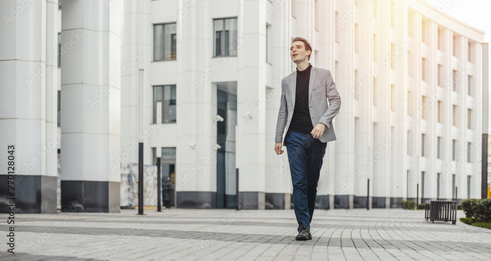 Distant plan of happy man going to or from work and dancing.