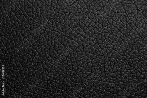 black leather texture or background with spotlight, dark tone.