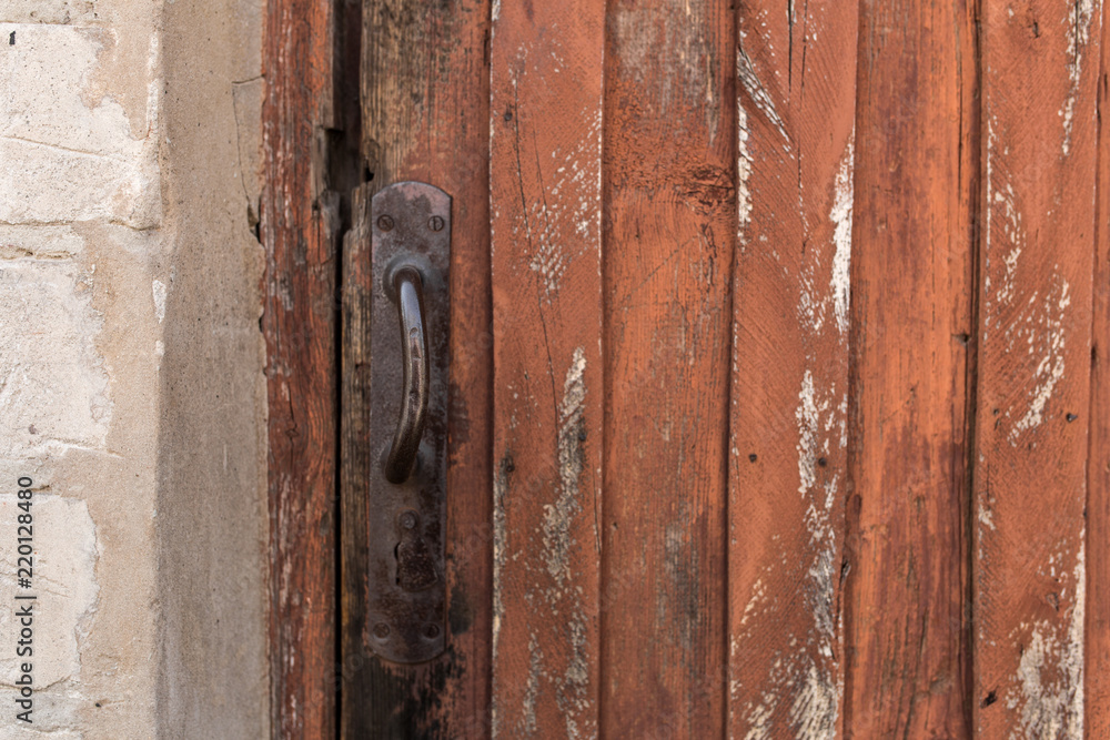 old wooden door with peeling and cracked red paint old wooden door with peeling and cracked red paint