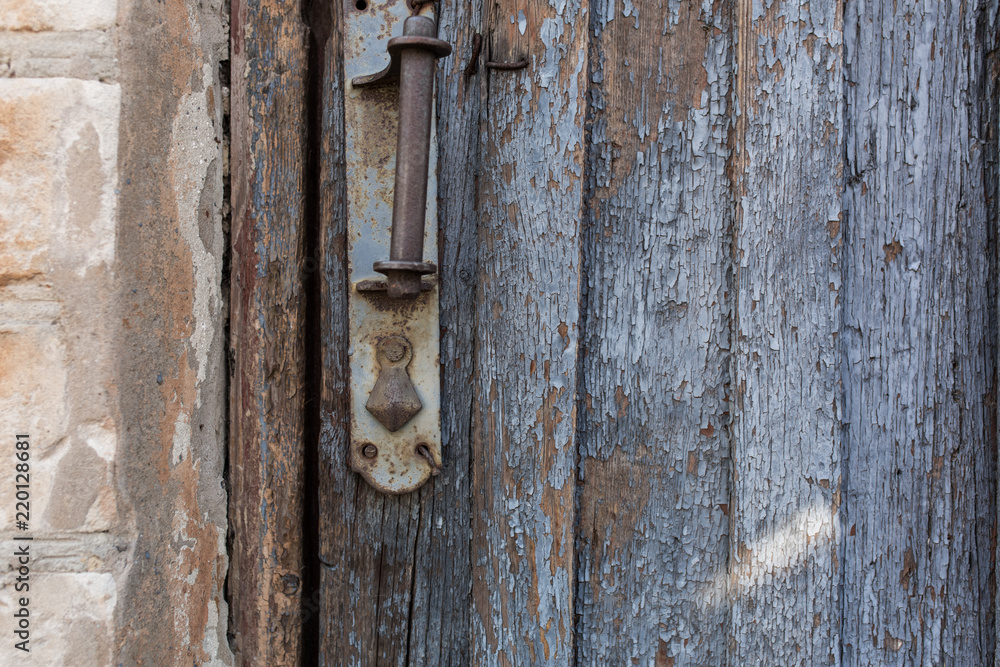 old wooden door with peeling and cracked grey paint old wooden door with peeling and cracked grey paint