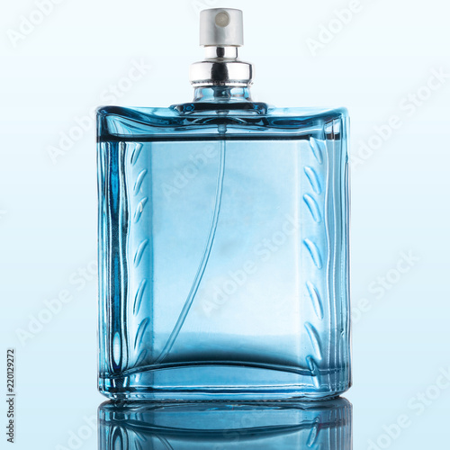 Blue Perfume Bottle, glass, on top of a reflective surface, isolated background