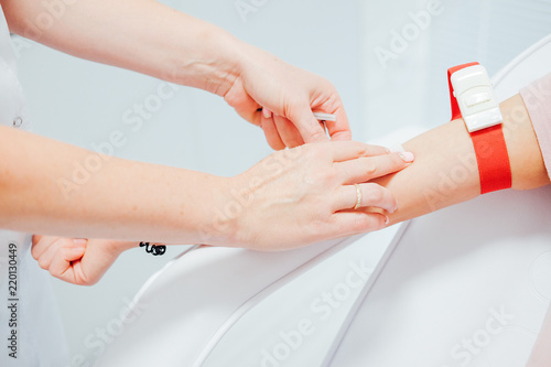 Nurse taking blood sample from the patient