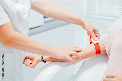 Nurse taking blood sample from the patient