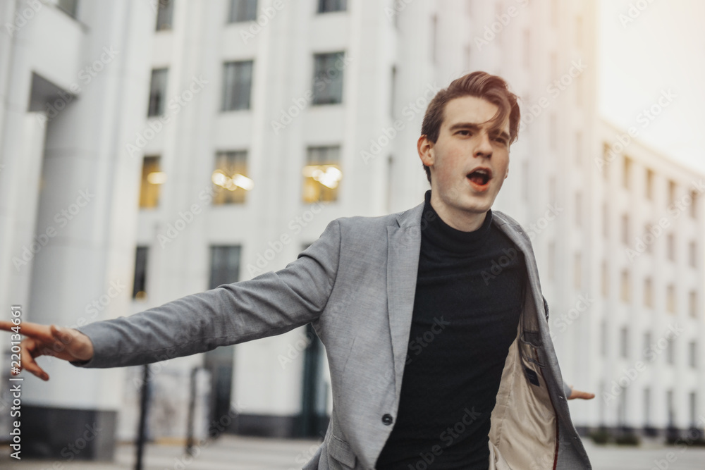 Close up of happy man smiling and raising his arms while going to or from work. Close up of happy man smiling and raising his arms while going to or from work.