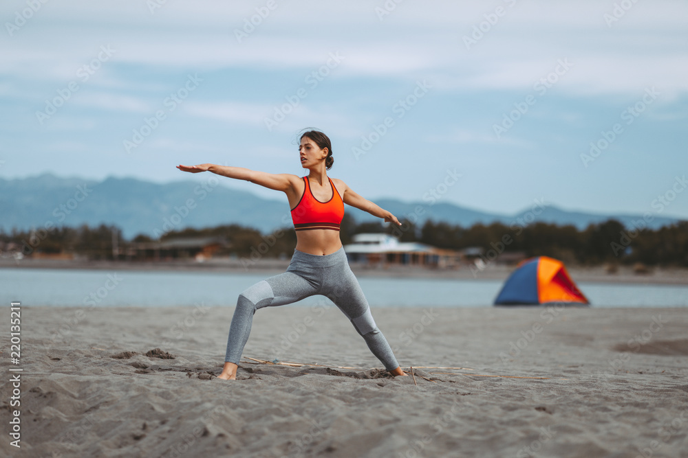 Young woman practicing yoga on the beach Young woman practicing yoga on the beach