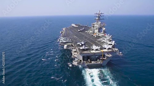 An aerial over an aircraft carrier at sea.