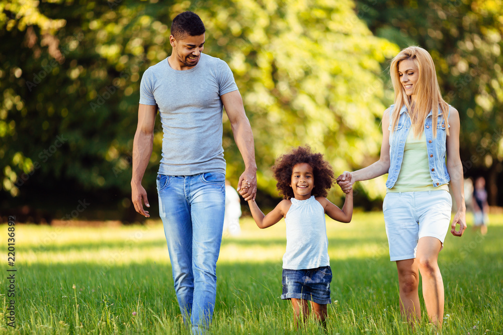 Fototapeta premium Happy young couple spending time with their daughter