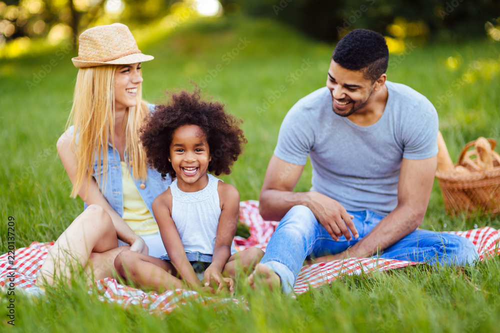 Picture of lovely couple with their daughter having picnic Picture of lovely couple with their daughter having picnic