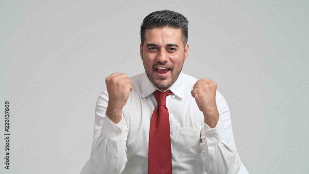 Excited Businessman portrait in white background. Young indian man in white shirt and red tie with excited looks in front to camera. Good news and achievement concept. Excited Businessman portrait in white background. Young indian man in white shirt and red tie with excited looks in front to camera. Good news and achievement concept.