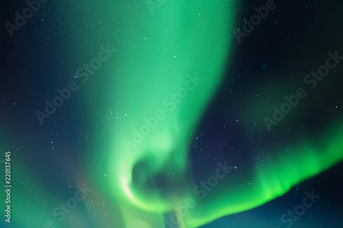 Night starry sky and Northern lights. Green aurora borealis