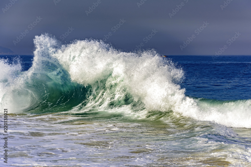 Big wave breaking on Ipanema beach during brazilian summer