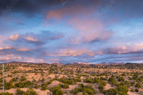 Dramatic colorful clouds at sunset over the Sangre de Cristo Mountains and desert near Santa Fe, New Mexico