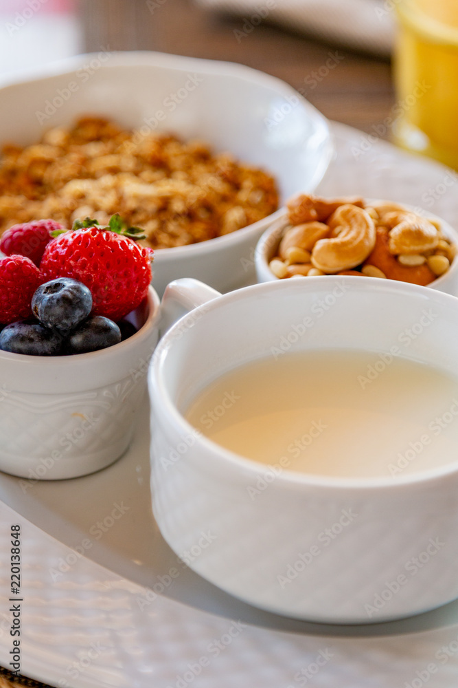 Healthy breakfast. Fresh juice, granola, muesli with milk and berries Healthy breakfast. Fresh juice, granola, muesli with milk and berries