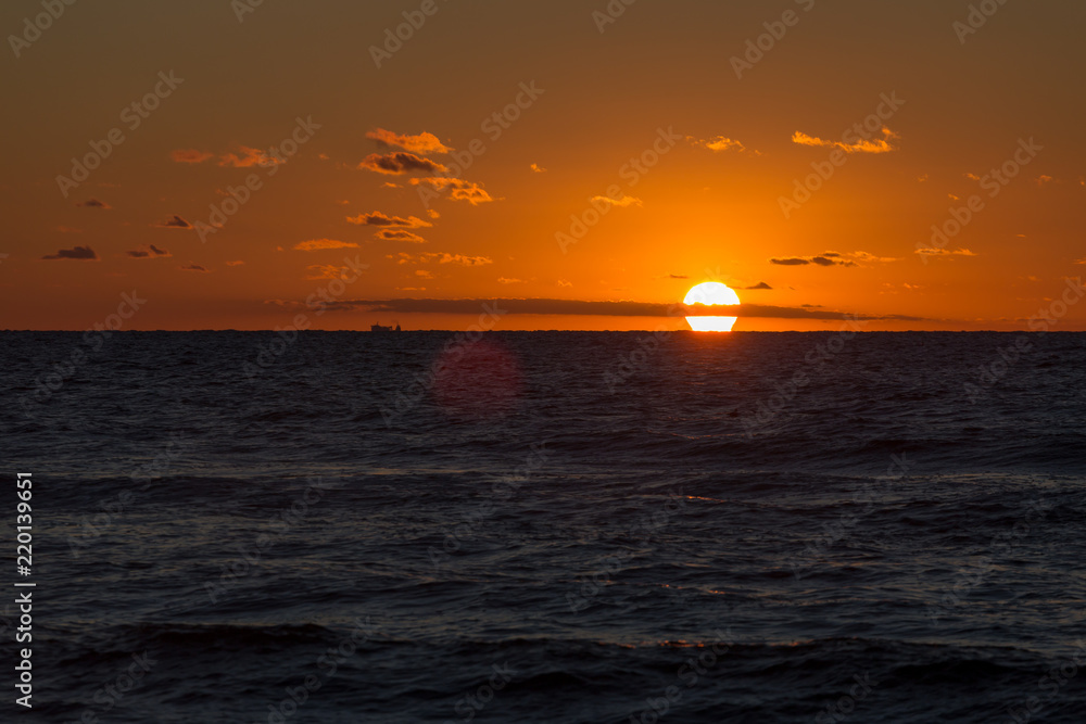 Beautiful golden sunset above the sea in summer