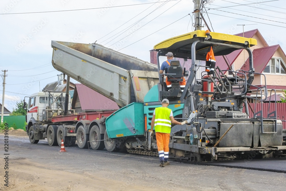 Work on laying of an asphalt paving by means of heavy machinery Work on laying of an asphalt paving by means of heavy machinery