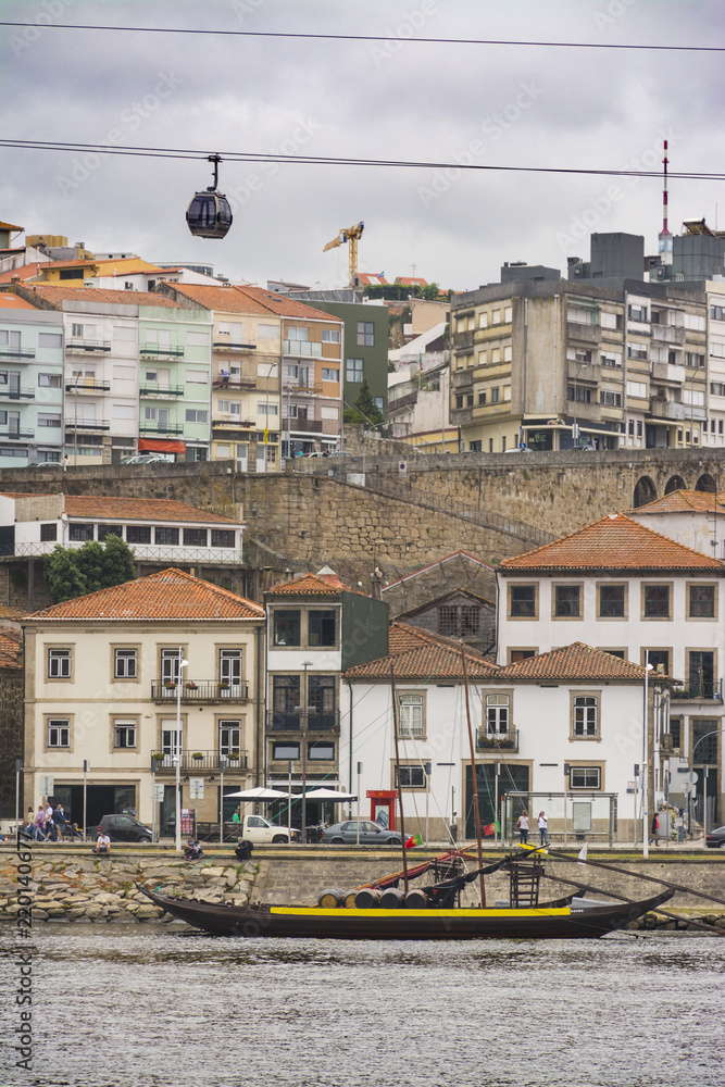 Boat in the Douro river with wine cellars, Porto, Portugal