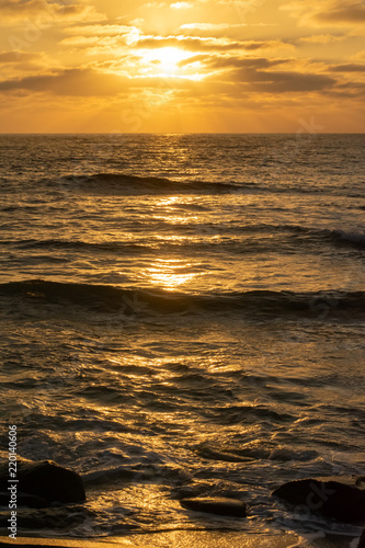 sunset over ocean with waves