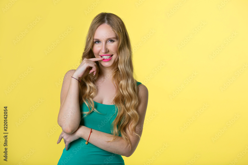 beautiful young girl with her hair on yellow background beautiful young girl with her hair on yellow background