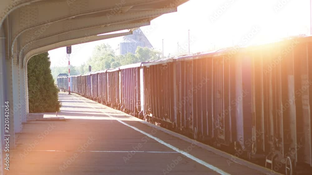 Cargo train moving through the train station in 4k slow motion Cargo train moving through the train station in 4k slow motion