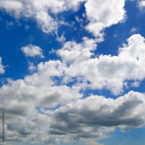 Light cumulus clouds in the blue sky.