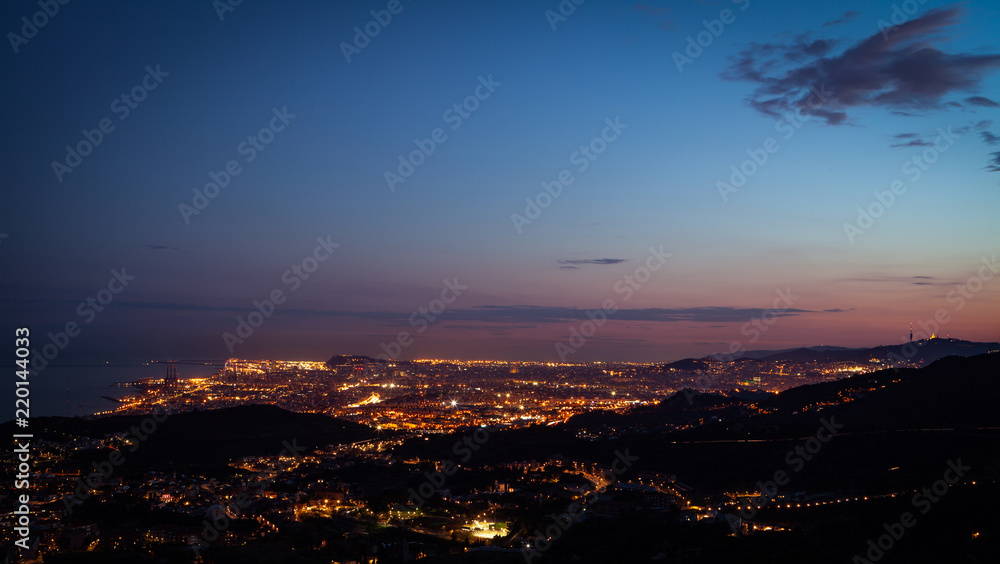 Fototapeta premium Skyline view of Barcelona City, Spain from mountain top during sunset