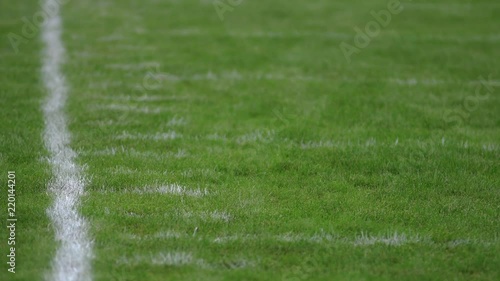 Football field sideline with yard hash marks, close up photo