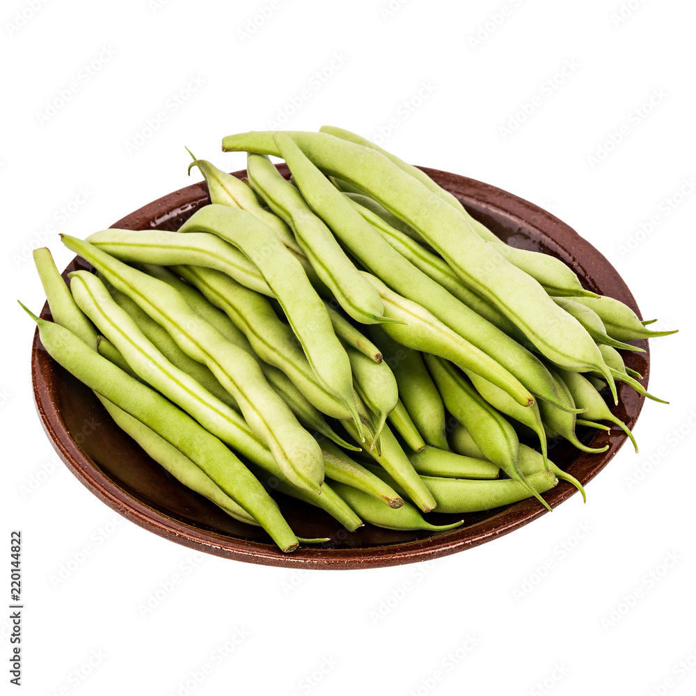 Fresh green beans in a clay plate on a table, white isolated background Fresh green beans in a clay plate on a table, white isolated background