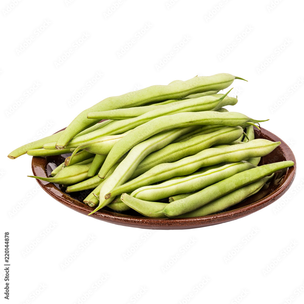 Fresh green beans in a clay plate on a table, white isolated background Fresh green beans in a clay plate on a table, white isolated background