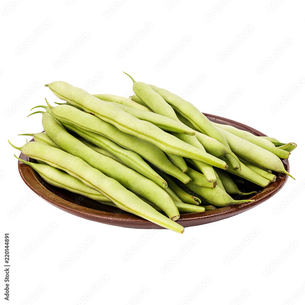 Fresh green beans in a clay plate on a table, white isolated background Fresh green beans in a clay plate on a table, white isolated background