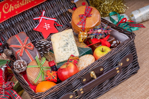Christmas Food Hamper.  Wicker Hamper loaded with Christmas Treats and Fruits photo