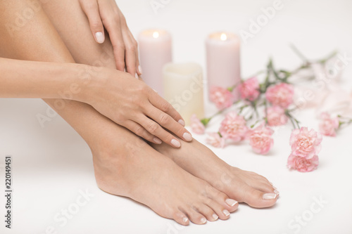 The picture of ideal done manicure and pedicure. Female hands and legs in the spa spot. © forma82